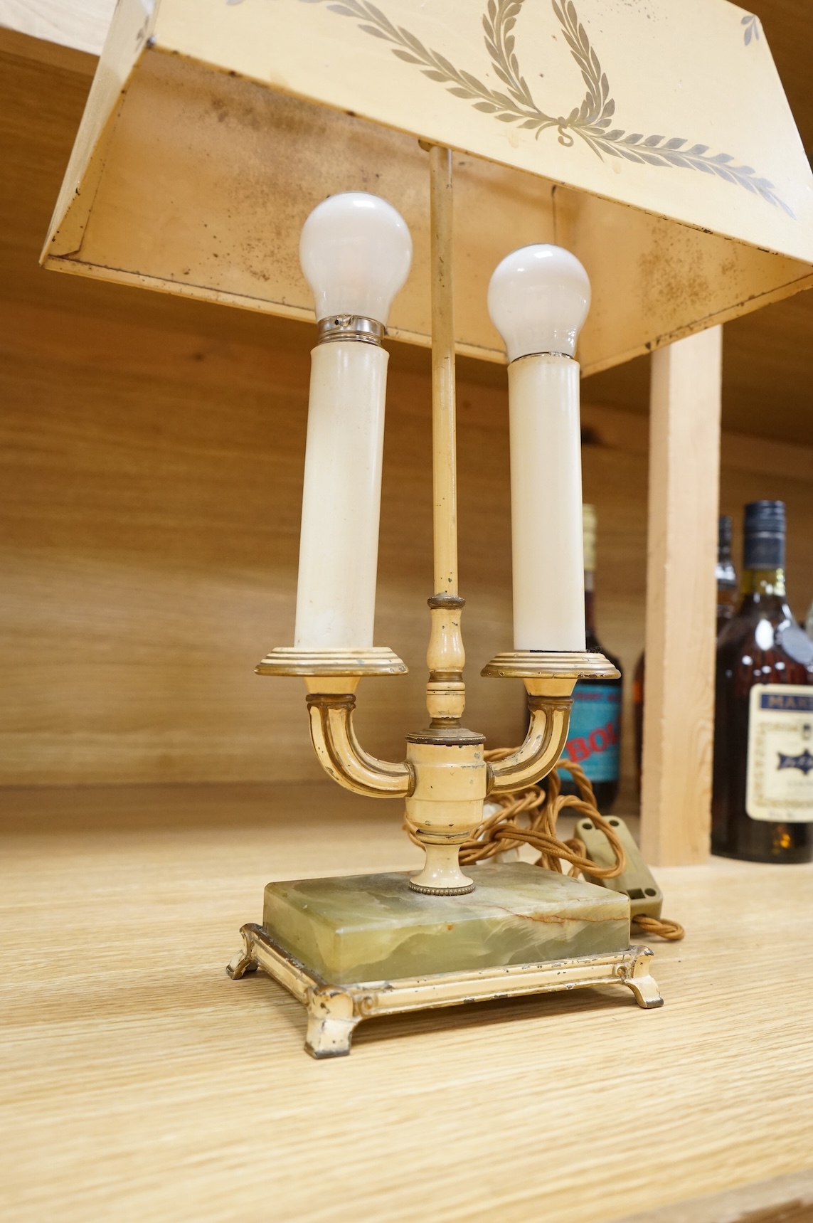 A cast brass wall sconce and a toleware two light lamp on onyx base, largest 46cm wide (2)